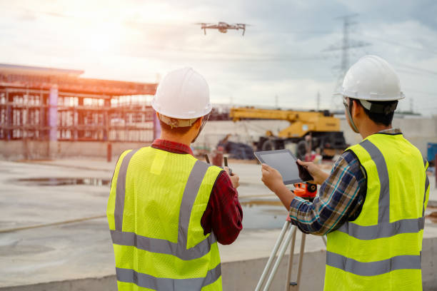 Drone operated by construction worker on building site,flying with drone.